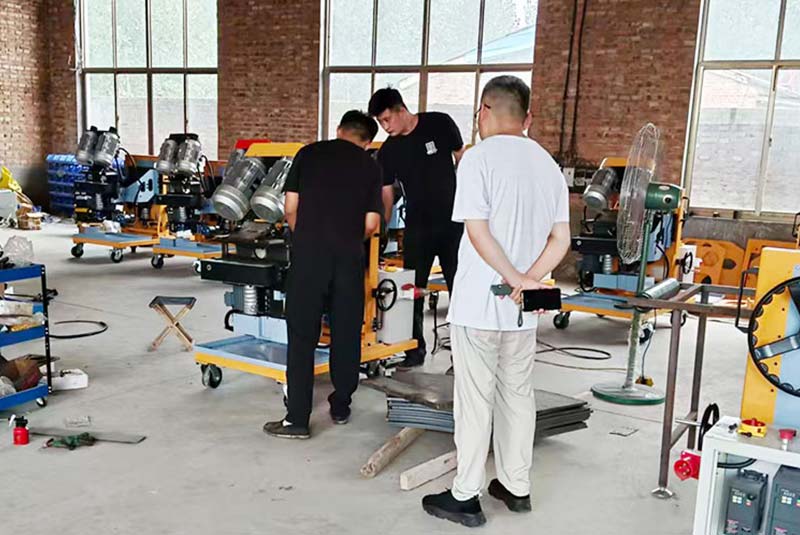 Visitors discussing beveling equipment in the workshop relevant to beveling machine quotation